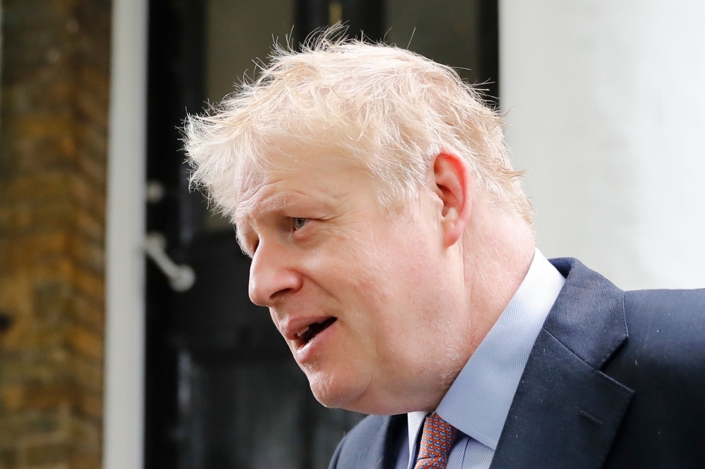 Conservative MP Boris Johnson leaves his home in London on Monday. — AFP