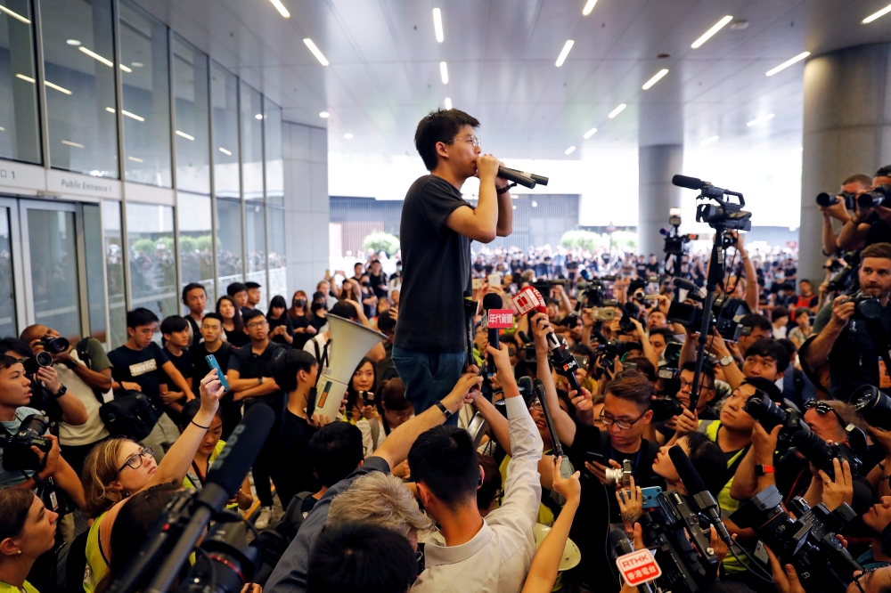 Pro-democracy activist Joshua Wong addresses the crowds outside the Legislative Council during a demonstration demanding Hong Kong's leaders to step down and withdraw the extradition bill, in Hong Kong, China, on Monday. — Reuters