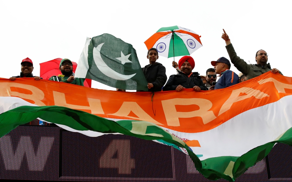 Pakistani cricket fans sit on the ground as they watch a screen displaying the ICC Cricket World Cup match between India and Pakistan in Manchester, at a park in Lahore, Pakistan on Sunday.  — Reuters