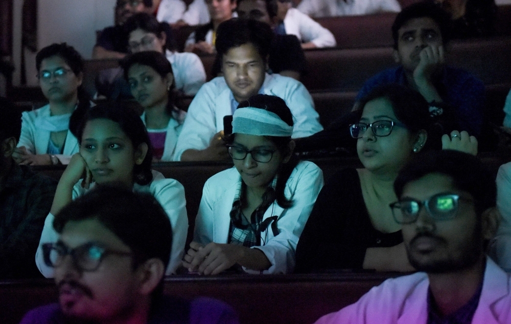 Indian doctors of All India Institute of Medical Science (AIIMS) watch the live streaming of the press conference of West Bengal Chief Minister Mamata Banerjee during a nationwide doctors strike in New Delhi on Monday. — AFP