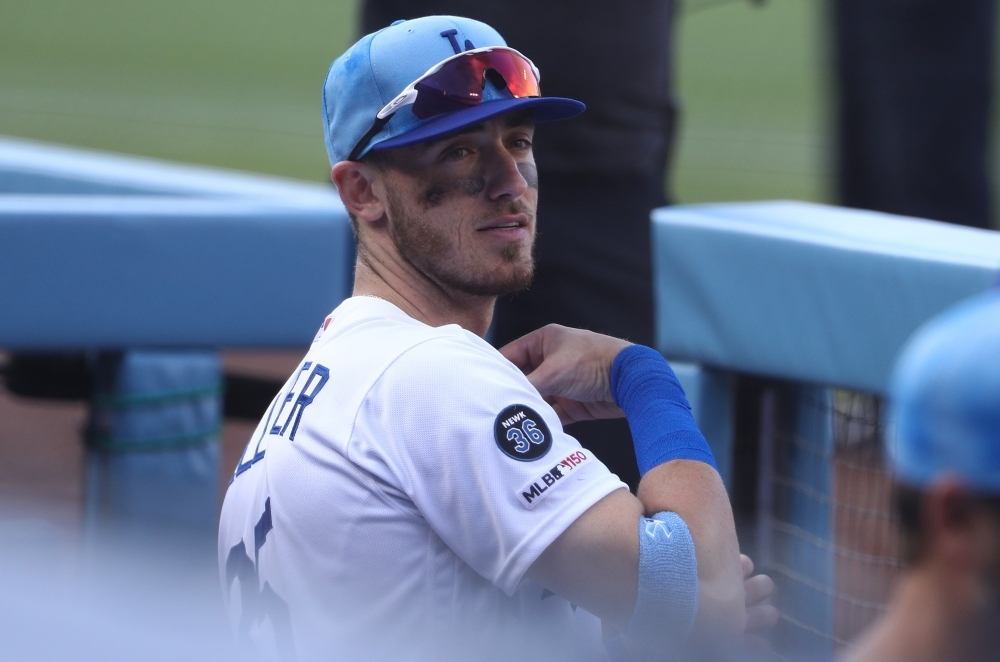Cody Bellinger No. 35 of the Los Angeles Dodgers looks on from the dugout bench after hitting a solo home run in the sixth inning of the MLB game against the Chicago Cubs at Dodger Stadium on Sunday in Los Angeles, California. The Dodgers defeated the Cubs 3-2. — AFP