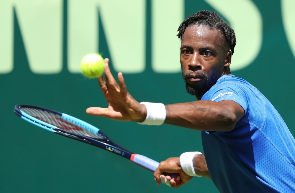 France's Gael Monfils returns the ball to France's Pierre-Hugues Herbert during their first round tennis match at the ATP Open tennis tournament in Halle, western Germany, on Monday. — AFP