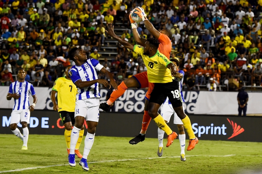 Jamaica's Brian Brown (No. 18) fights for the ball with Honduras's Maynor Figueroa (No. 3) during the 2019 Concacaf Gold Cup match between Jamaica and Honduras on Monday at Independence Park in Kingston. — AFP 