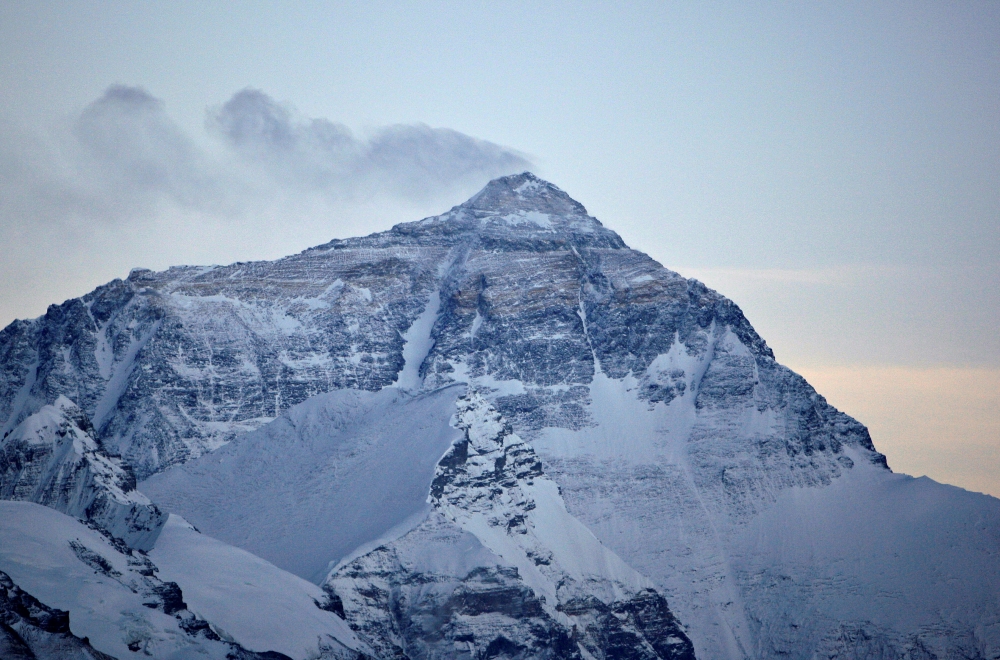 Wind blows snow off the summit at dusk of the world's highest mountain Mount Everest, also known as Qomolangma, in the Tibet Autonomous Region, in this May 5, 2008 file photo. — Reuters
