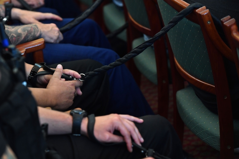 Defendants listen to the final verdict in their trial for the gruesome deaths of 71 migrants who suffocated in a lorry nearly four years ago at a court in Szeged, Hungary, on Thursday. — AFP