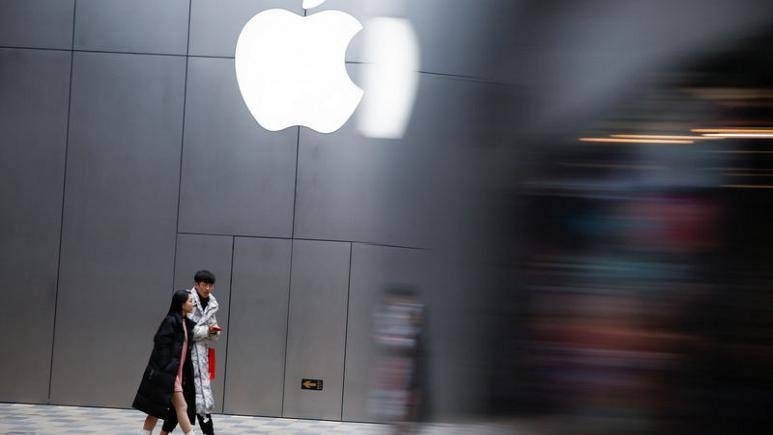 People walk past an Apple store in Beijing, China. — Reuters