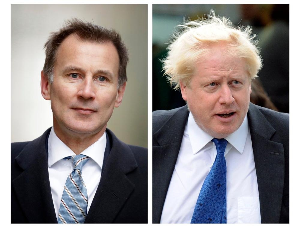 British Foreign Secretary Jeremy Hunt, left, and former British Foreign Secretary are seen in this file combo picture. — AFP