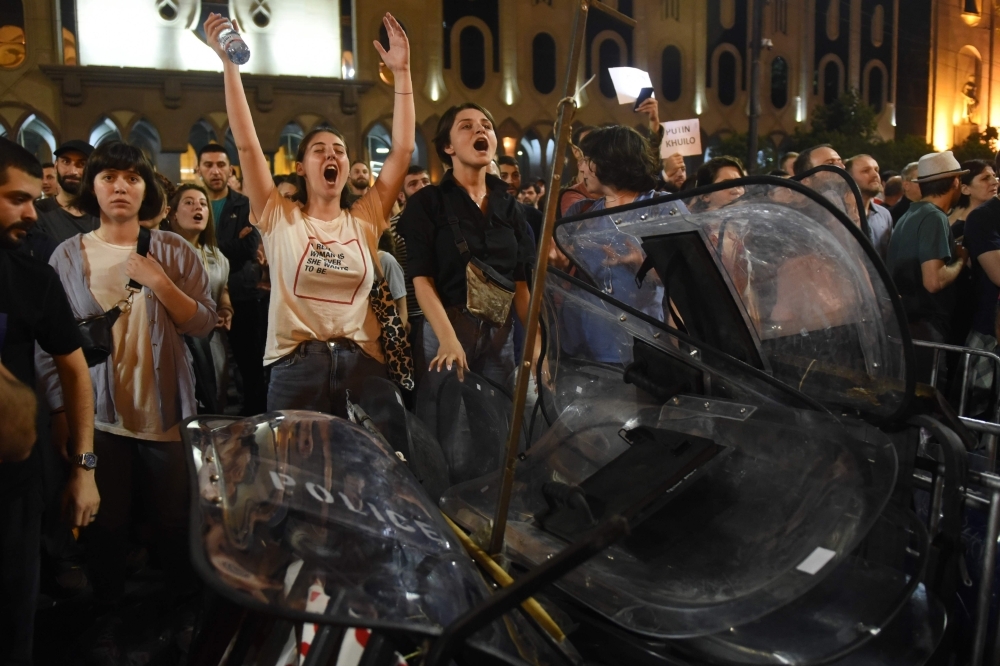 People rally outside the parliament in Tbilisi on Thursday. — AFP