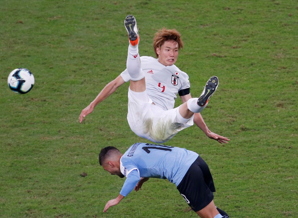Japan's Ko Itakura in action with Uruguay's Giorgian de Arrascaeta during the Copa America Brazil 2019 Group C match at the Arena Do Gremio, Porto Alegre, Brazil. — Reuters