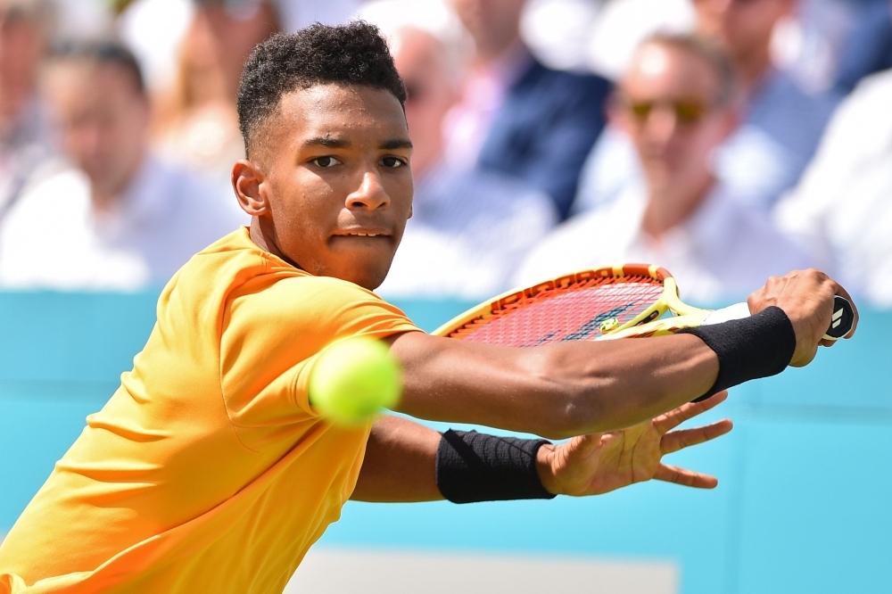 Canada's Felix Auger Aliassime returns to Greece's Stefanos Tsitsipas during their men's singles quarter final tennis match at the ATP Fever-Tree Championships tournament at Queen's Club in west London on Friday. — AFP