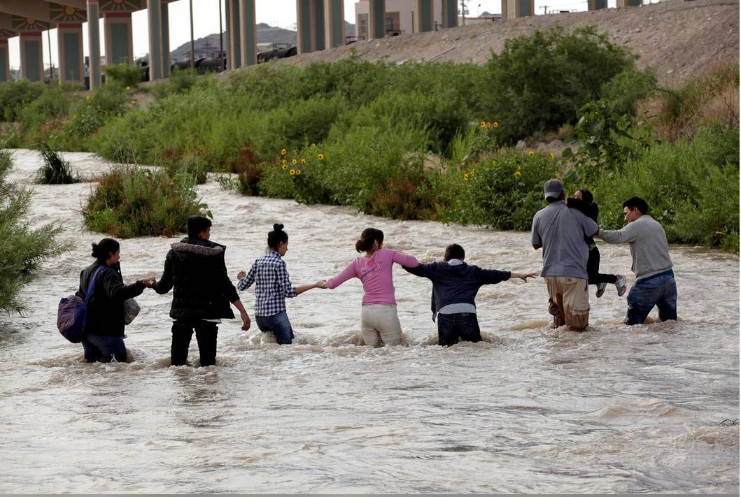 Migrants from Central America form a human chain to cross the Rio Bravo river to enter illegally into the United States to turn themselves in to request for asylum in El Paso, Texas, as seen from Ciudad Juarez, Mexico. — Reuters