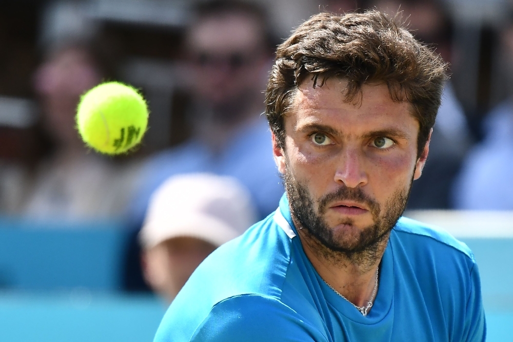 France's Gilles Simon keeps his eyes on the ball as he returns against Russia's Daniil Medvedev in their men's singles semifinal tennis match at the ATP Fever-Tree Championships tournament at Queen's Club in west London on Saturday. — AFP
