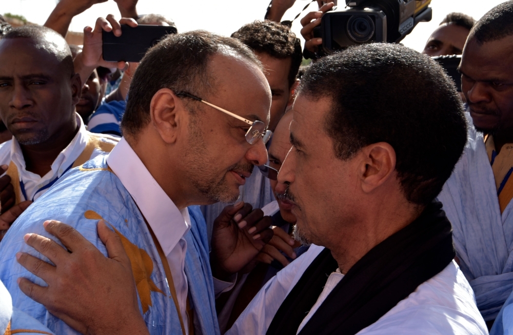 Mauritania's main opposition challenger Sidi Mohamed Ould Boubacar (left) speaks with fellow candidate of the UFP leftist party Mohamed Ould Mouloud as he leaves a polling station after casting his vote Saturday in Nouakchott during the country's presidential election. — AFP