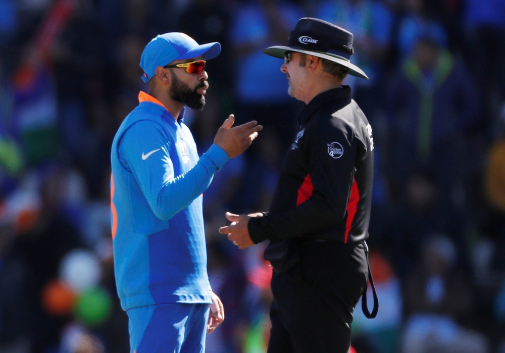 India's skipper Virat Kohli talks to umpire Richard Illingworth during the ICC Cricket World Cup match against Afghanistan at The Ageas Bowl, Southampton, Britain, on Saturday. — Reuters