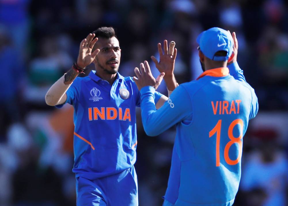 India's Yuzvendra Chahal celebrates taking the wicket of Afghanistan's Rashid Khan with Virat Kohli during the ICC Cricket World Cup match at The Ageas Bowl, Southampton, Britain, on Saturday. — Reuters