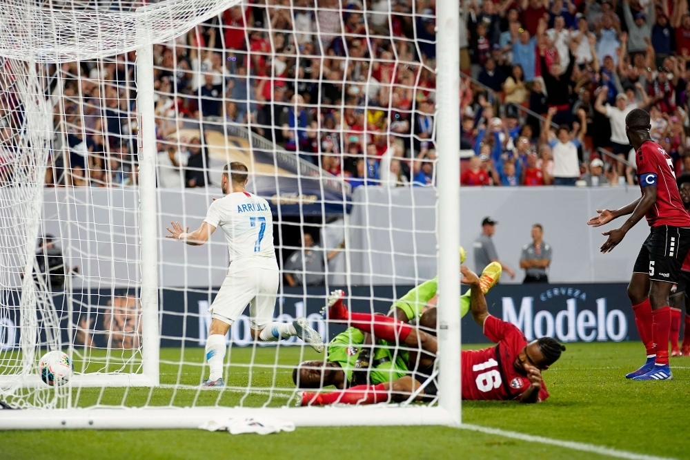 Paul Arriola No. 7 of the USA celebrates after beating Marvin Phillip No. 1 of Trinidad and Tobago for a goal during the second half of the CONCACAF Gold Cup Group D match at FirstEnergy Stadium on Saturday in Cleveland, Ohio. The USA defeated Trinidad and Tobago 6-0. — AFP
