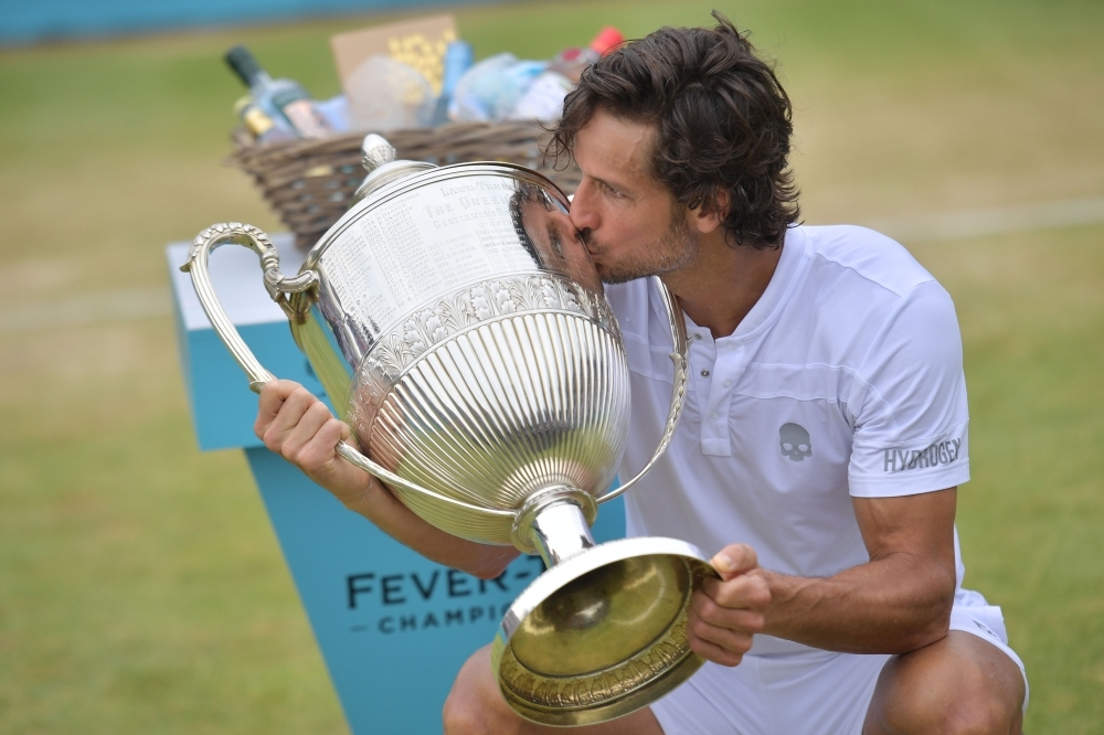 Spain's Feliciano Lopez kisses the winner's trophy after his victory over France's Gilles Simon in the men's singles final tennis match at the ATP Fever-Tree Championships tournament at Queen's Club in west London on Sunday. Feliciano Lopez became at 37 the oldest Queen's singles champion. — AFP