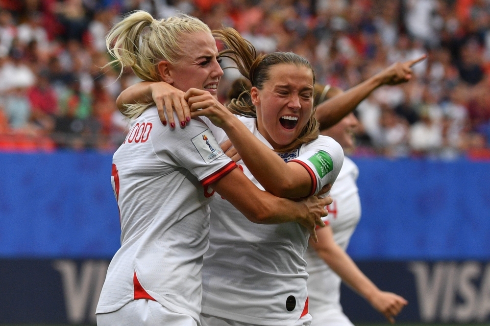 England's defender Alex Greenwood (L) is congratulated by teammates after scoring a goal during the France 2019 Women's World Cup round of sixteen football match between England and Cameroon, on Sunday, at the Hainaut stadium in Valenciennes, northern France. — AFP