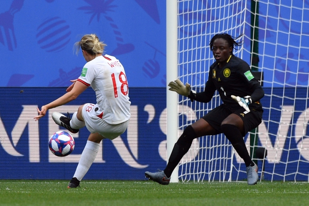 England's defender Alex Greenwood (L) is congratulated by teammates after scoring a goal during the France 2019 Women's World Cup round of sixteen football match between England and Cameroon, on Sunday, at the Hainaut stadium in Valenciennes, northern France. — AFP