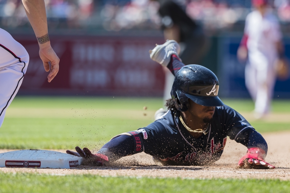 Ozzie Albies No. 1 of the Atlanta Braves beats the throw to first against the Washington Nationals during the tenth inning at Nationals Park on Sunday in Washington, DC. — AFP