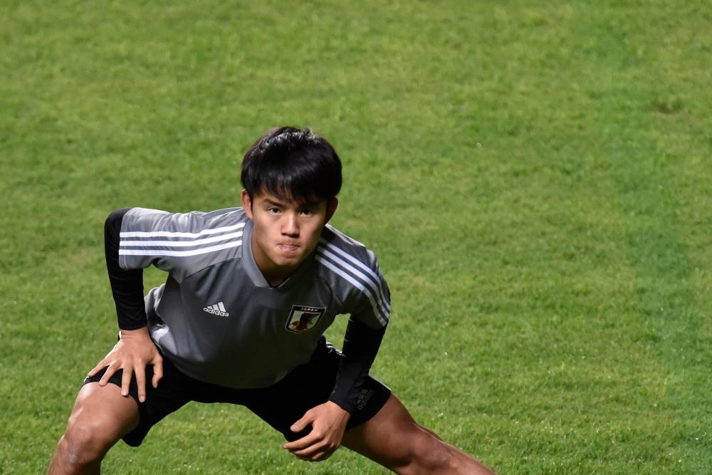 Japan's Takefusa Kubo stretches during a training session of the national team at the Independencia stadium, in Belo Horizonte, Brazil, on Friday, during the Copa America football tournament. — AFP