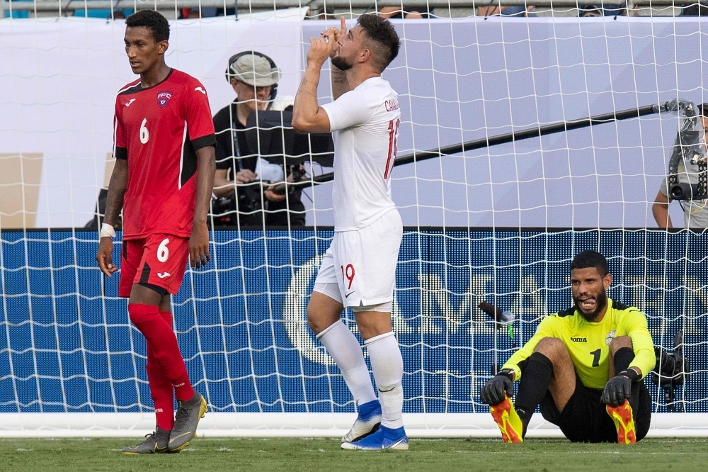 Canada's Lucas Cavallini (C) celebrates after scoring a goal on Cuba's Sandy Sanchez (R) as Yosel Piedra (L) looks on during their CONCACAF Gold Cup group stage football match at Bank of America Stadium in Charlotte, North Carolina, on Sunday. — AFP