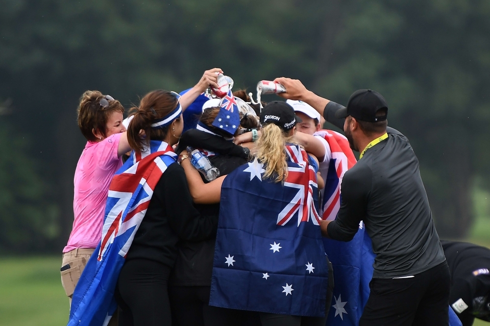 Hannah Green of Australia is congratulated by friends on the 18th green after winning the KPMG PGA Championship at Hazeltine National Golf Club on Sunday in Chaska, Minnesota. — AFP