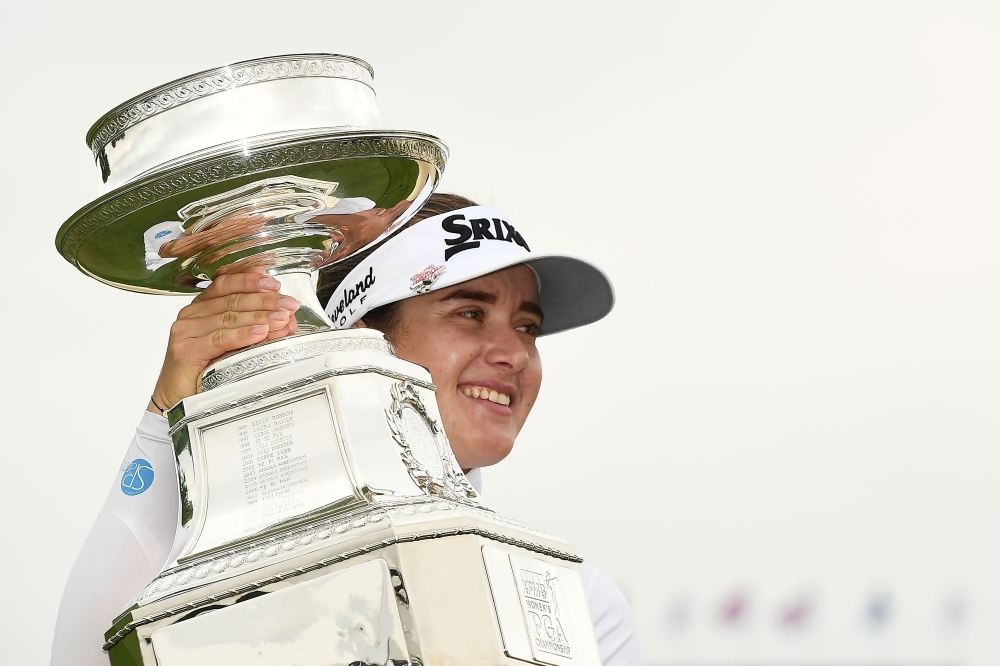 Hannah Green of Australia is congratulated by friends on the 18th green after winning the KPMG PGA Championship at Hazeltine National Golf Club on Sunday in Chaska, Minnesota. — AFP