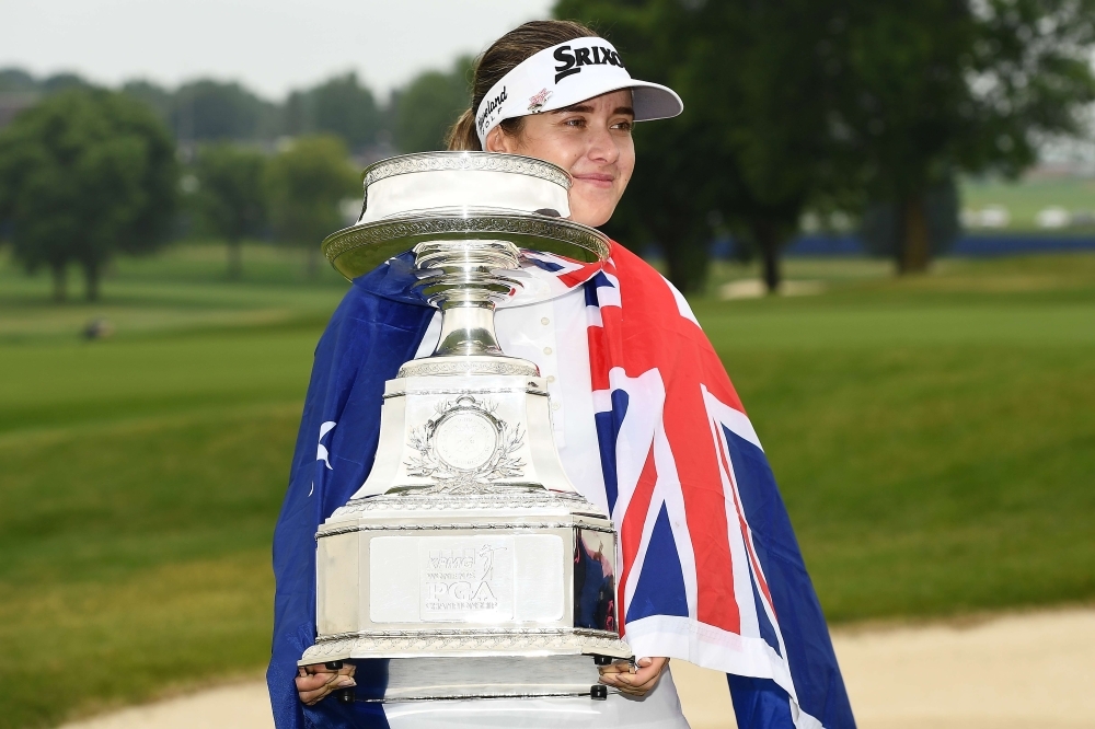 Hannah Green of Australia is congratulated by friends on the 18th green after winning the KPMG PGA Championship at Hazeltine National Golf Club on Sunday in Chaska, Minnesota. — AFP