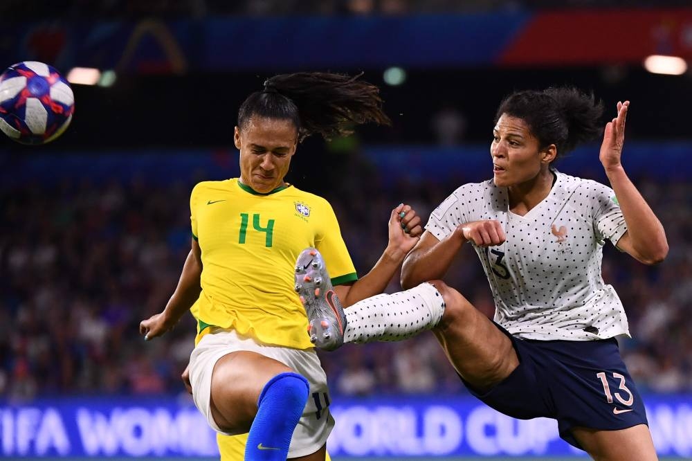 France's Gaetane Thiney and Amandine Henry in action with Brazil's Marta during the Women's World Cup round of 16 match at the Stade Oceane, Le Havre, France on Sunday. — Reuters