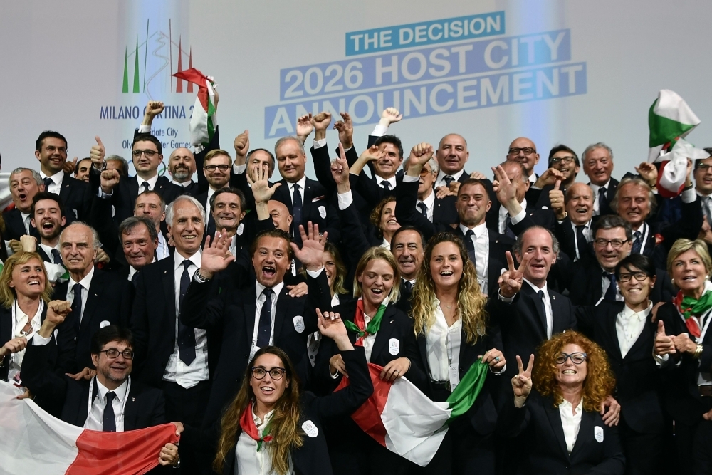 Members of the delegation of Milan/Cortina d'Ampezzo 2026 Winter Olympics candidate city react after the city was elected to host the 2026 Olympic Winter Games during the 134th session of the International Olympic Committee (IOC), in Lausanne on Monday. — AFP