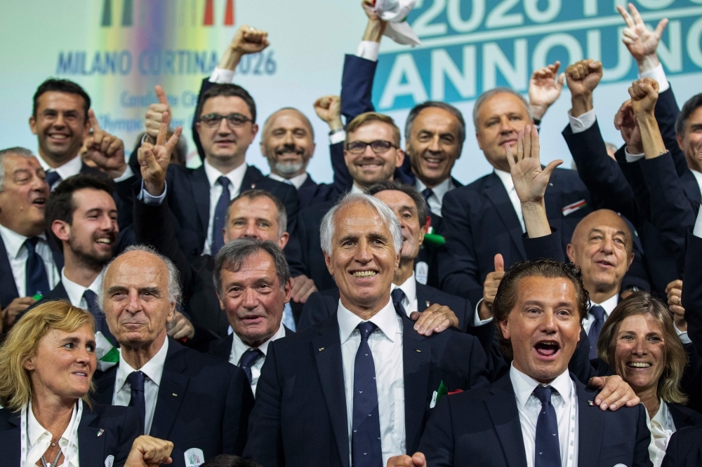 International Olympic Committee (IOC) president Thomas Bach shows the card with the name Milan/Cortina d'Ampezzo as the winning name of the 2026 Winter Olympics during the 134th session of the International Olympic Committee (IOC), in Lausanne on Monday. — AFP