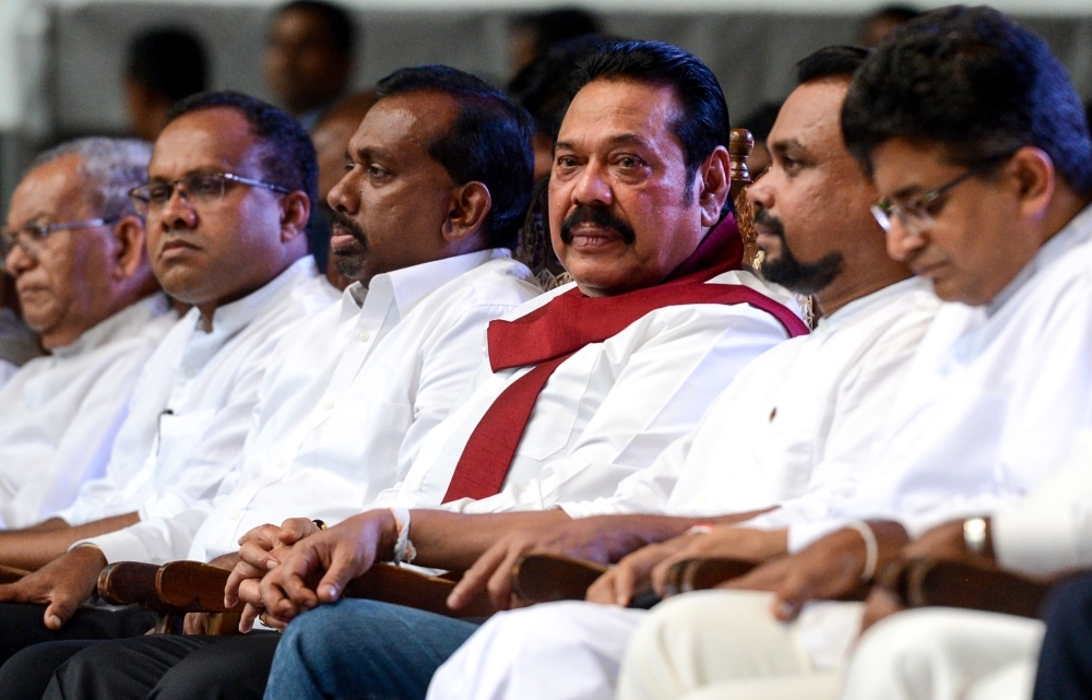 Sri Lankan former President Mahinda Rajapaksa, center, looks on during a remembrance ceremony in Colombo on June 21, 2019, two months ago after Easter Sunday bombings targeting churches and luxury hotels that killed 258 people. — AFP
