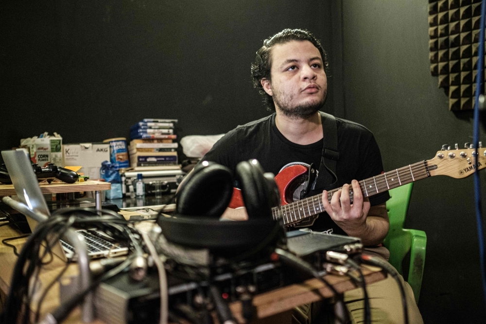 Sudanese music producer and guitarist Amjad Badr plays the guitar at Sudanese English-language Capital Radio in Khartoum. A surge of freedom has taken over Sudan's underground music scene since the army ousted longtime ruler Omar Al-Bashir in April after months of nationwide protests against his rule. From rap to afrobeat, musicians living in Sudan and overseas have composed tunes punctuated by some of the protest movement's most popular slogans. — AFP photos