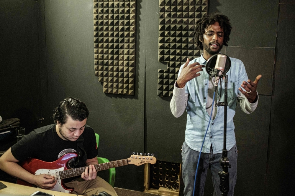 Sudanese music producer and guitarist Amjad Badr plays the guitar at Sudanese English-language Capital Radio in Khartoum. A surge of freedom has taken over Sudan's underground music scene since the army ousted longtime ruler Omar Al-Bashir in April after months of nationwide protests against his rule. From rap to afrobeat, musicians living in Sudan and overseas have composed tunes punctuated by some of the protest movement's most popular slogans. — AFP photos