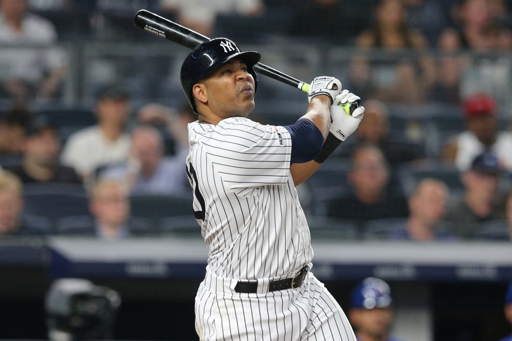 New York Yankees designated hitter Edwin Encarnacion (30) follows through on a solo home run against the Toronto Blue Jays during the eighth inning at Yankee Stadium. — Reuters