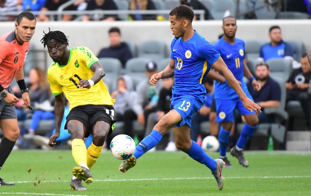 Shamar Nicholson of Jamaica (L) shoots under pressure from Jurien Gaari of Curacao during the Group B Concacaf Gold Cup first round football match between Jamaica and Curacao in Los Angeles on Tuesday. — AFP 