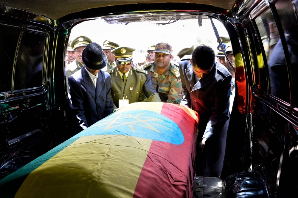 Members of the army carry one of the coffins covered with the Ethiopian national flag as they arrive at the millennium hole in Addis Ababa on Tuesday for the national funeral service of Chief of Staff of the Ethiopian defense forces Seare Mekonnen and of Major-General Geza'e Abera, a retired former senior official in the Ethiopian army. — AFP