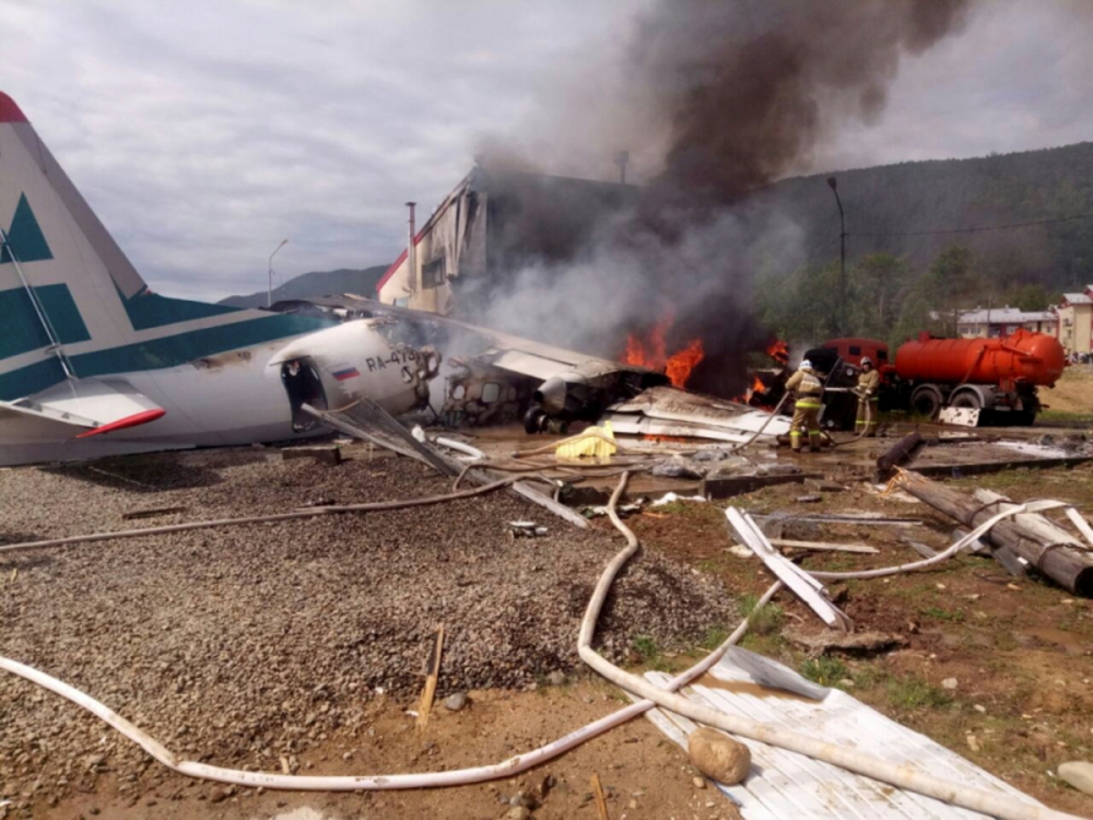 An Antonov An-24 passenger plane is seen on fire after an emergency landing in the town of Nizhneangarsk, Russia, on Thursday. — AFP