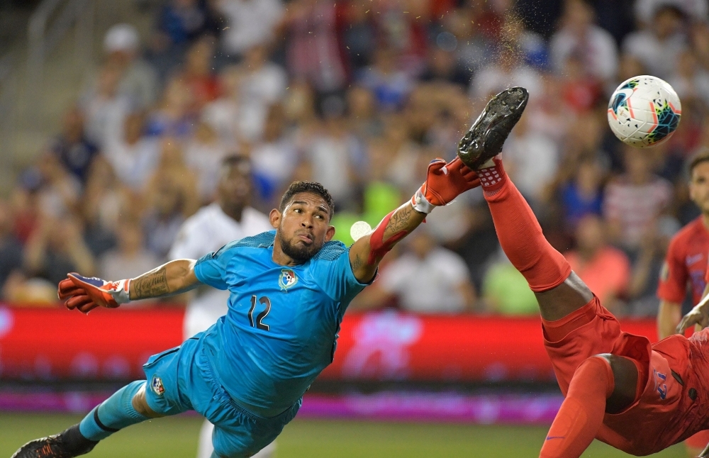 Panama's Jose Calderon (12) reaches for the ball just after USA's Jozy Altidore (17) did a bicycle kick and scored during their Gold Cup Group D match on Wednesday at Children's Mercy Park in Kansas City, Kansas. — AFP