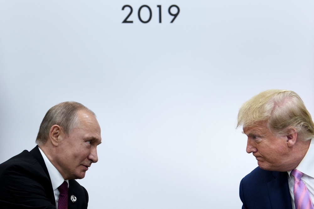 US President Donald Trump, right, attends a meeting with Russia's President Vladimir Putin during the G20 summit in Osaka, Japan, on Friday. — AFP