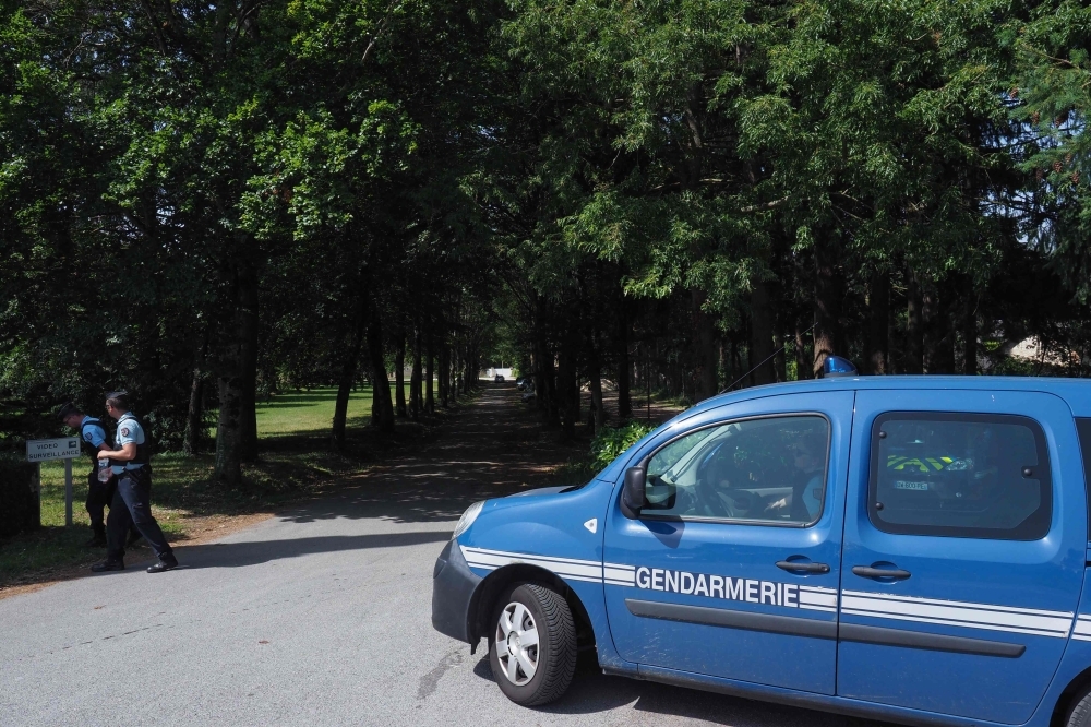 French Gendarmes stand next to their car at the entrance of Notre Dame Abbey of Fontgombault, central France, where French citizen Jean-Claude Romand arrived from the Saint-Maur prison during the night, on Friday. — AFP