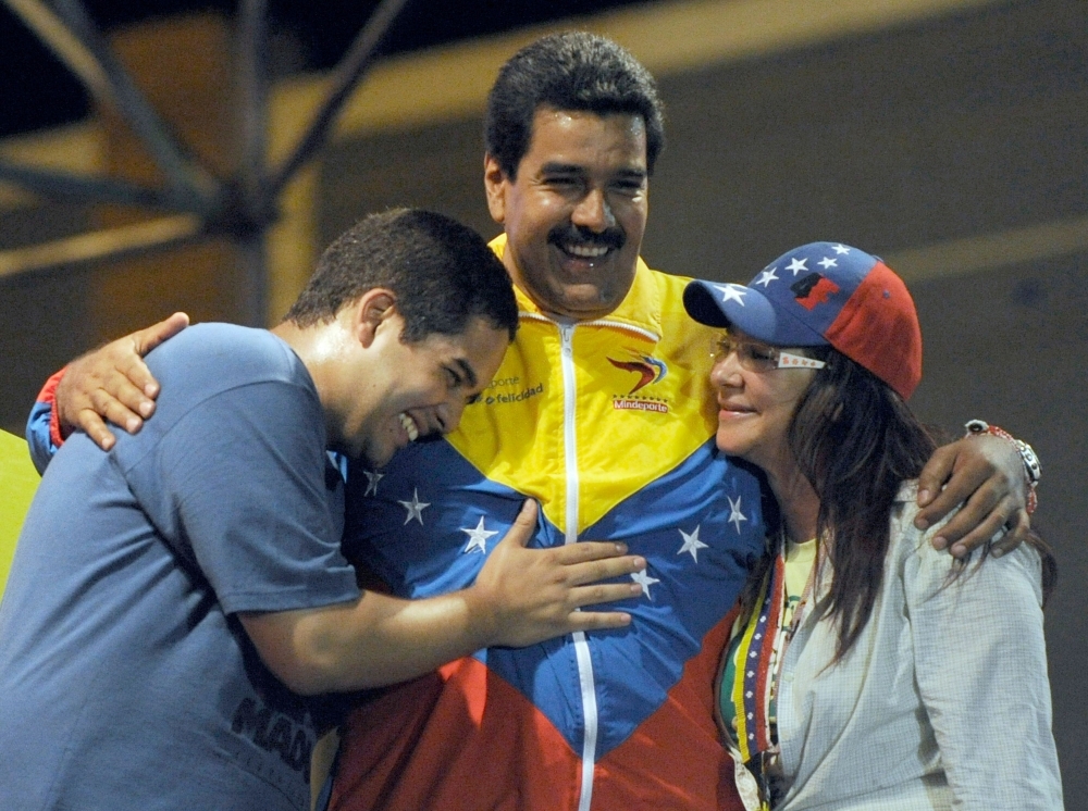 Venezuelan acting President Nicolas Maduro, center, embraces his wife Cilia Flores, left, and son Nicolas Maduro during a campaign rally in Puerto Ordaz, Bolivar state, Venezuela, in this April 6, 2013 file photo. — AFP