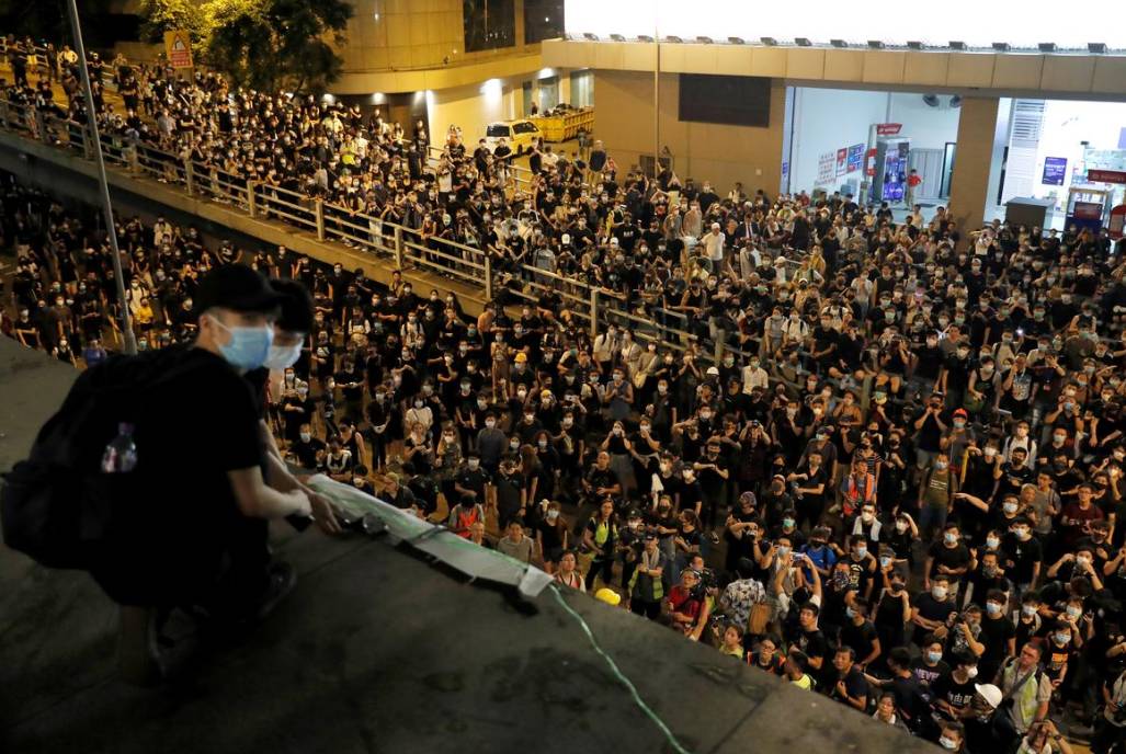 Protesters hang a banner as they siege police headquarters in Hong Kong after a rally ahead of the G20 summit, urging the international community to back their demands for the government to withdraw an extradition bill, June 26. -Reuters