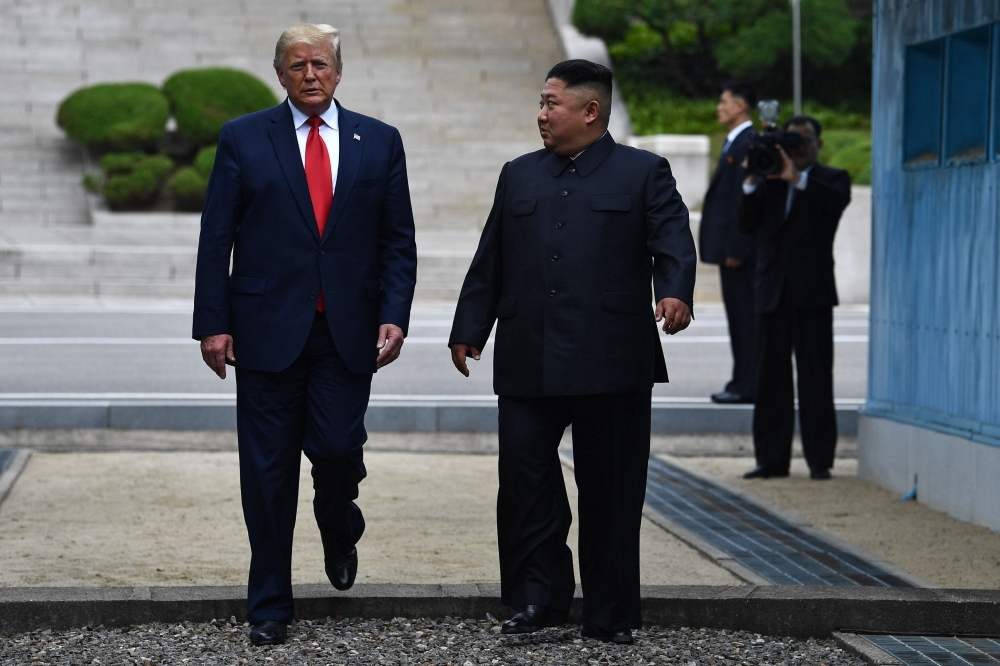 North Korea's leader Kim Jong Un walks southward with US President Donald Trump, after Trump briefly stepped into the north of the Military Demarcation Line that divides North and South Korea, in the Joint Security Area (JSA) of Panmunjom in the Demilitarized zone DMZ. AFP