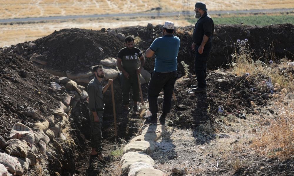 Volunteers prepare meals to be delivered to fighters, in the town of Atarib, Syria.