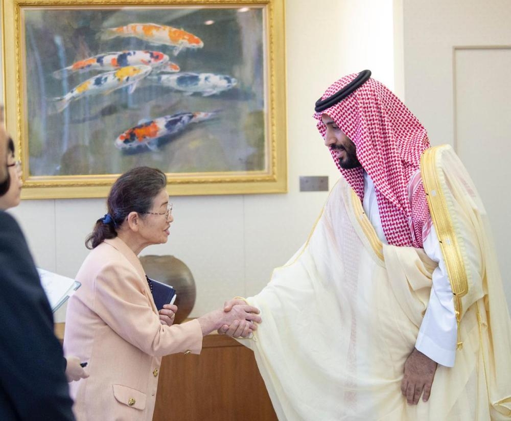 Crown Prince Muhammad Bin Salman and Japanese Prime Minister Shinzo Abe shake hands during their meeting in Osaka, western Japan Sunday. — Reuters