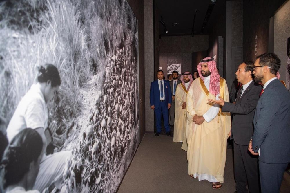 Crown Prince Muhammad Bin Salman and Japanese Prime Minister Shinzo Abe shake hands during their meeting in Osaka, western Japan Sunday. — Reuters