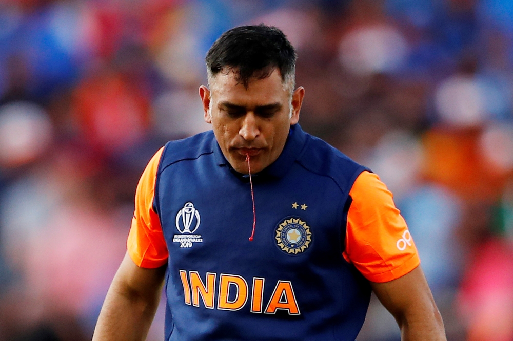 India's MS Dhoni spits out blood after sucking his cut thumb during the ICC Cricket World Cup match against England at Edgbaston, Birmingham, Britain on Sunday. —  Reuters