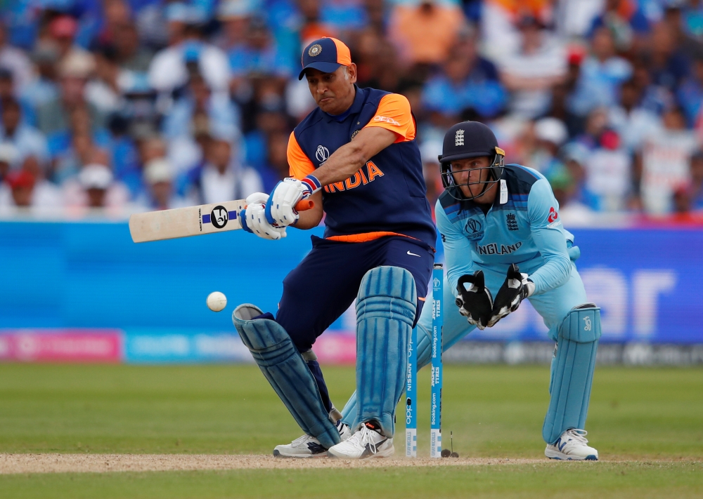 India's MS Dhoni spits out blood after sucking his cut thumb during the ICC Cricket World Cup match against England at Edgbaston, Birmingham, Britain on Sunday. —  Reuters